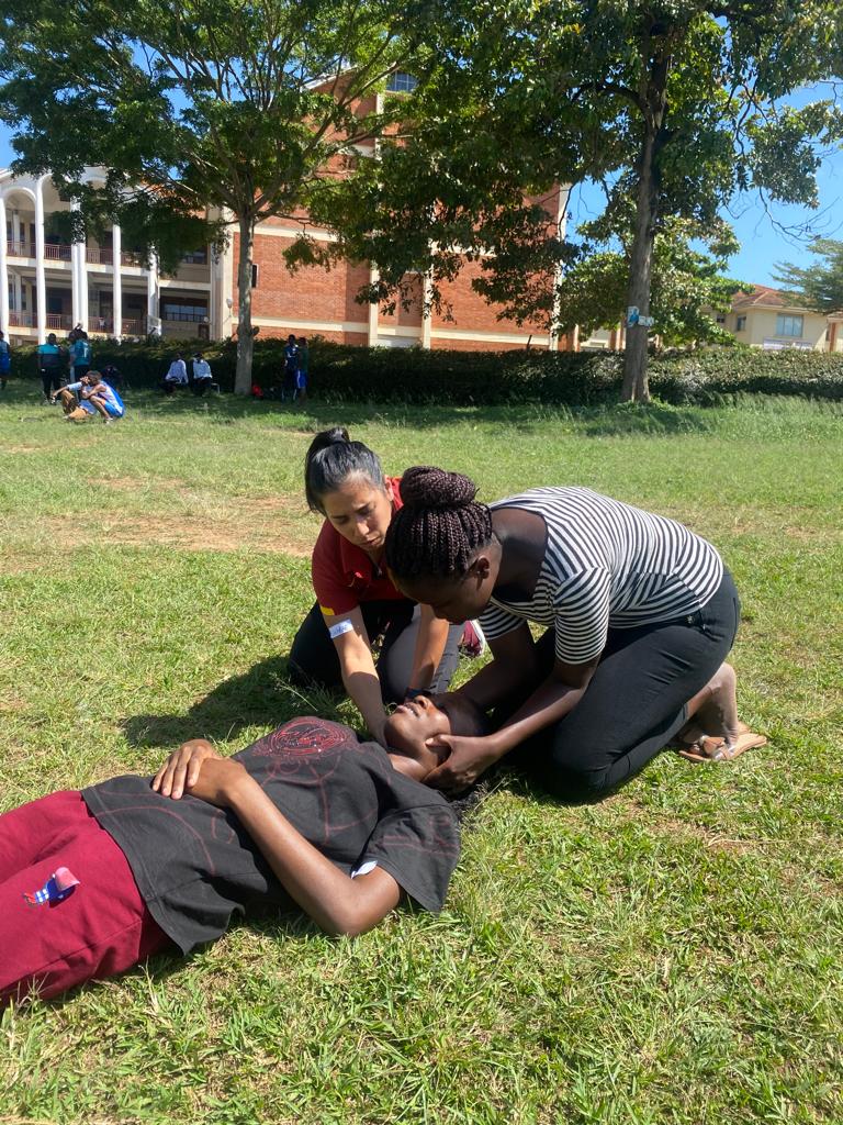 Sharae Tejada instructing Uganda students about physical therapy