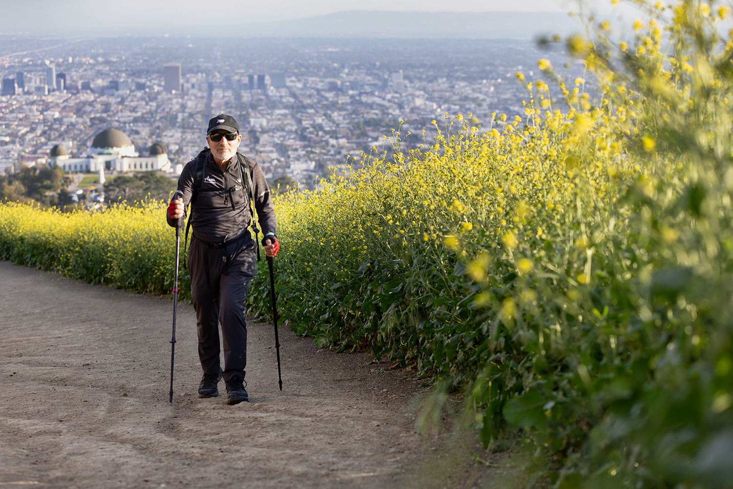 Bob Parsons hiking on a mountaintop with Los Angeles in the background