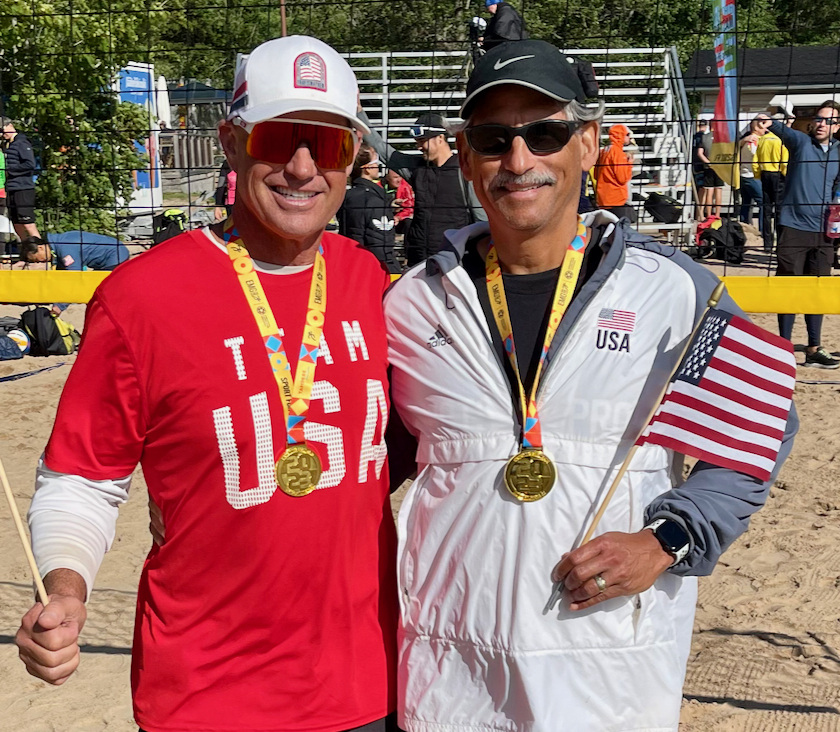 Rob Landel and teammate with gold medals on volleyball court