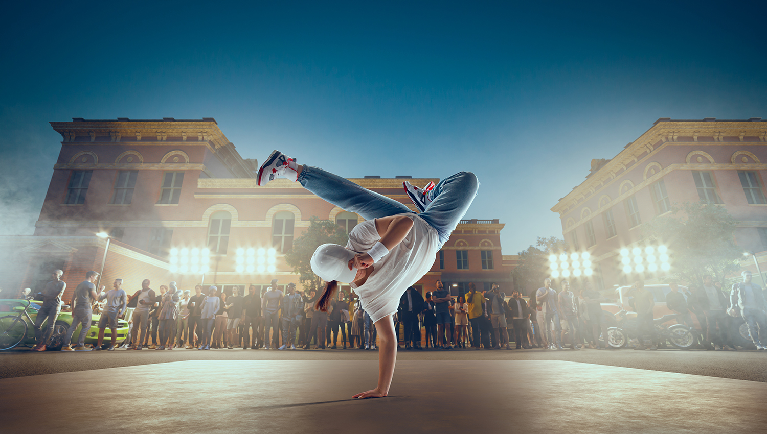 breakdancer breaking in front of buildings