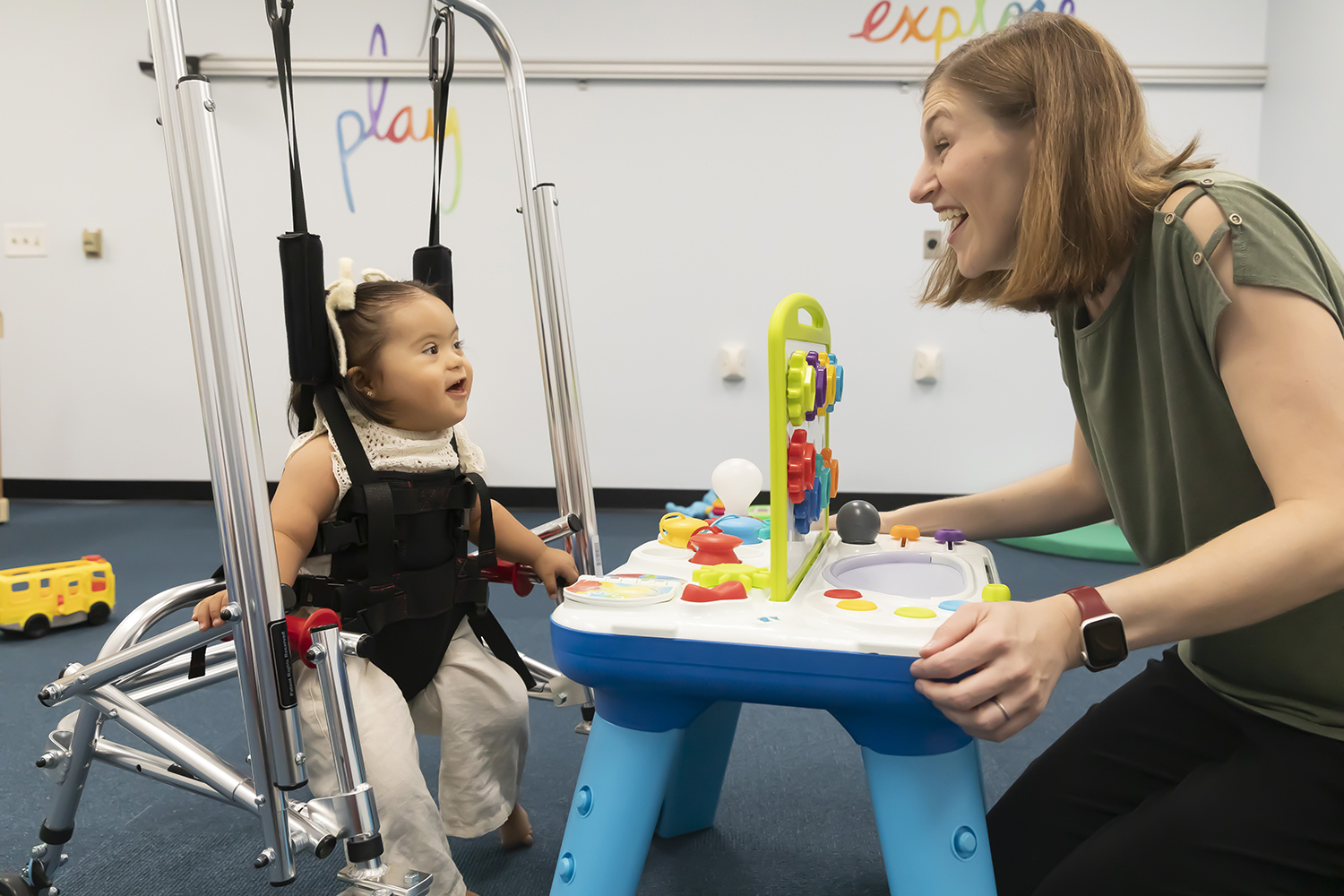 Researcher interacting with infant in a waking assisted device