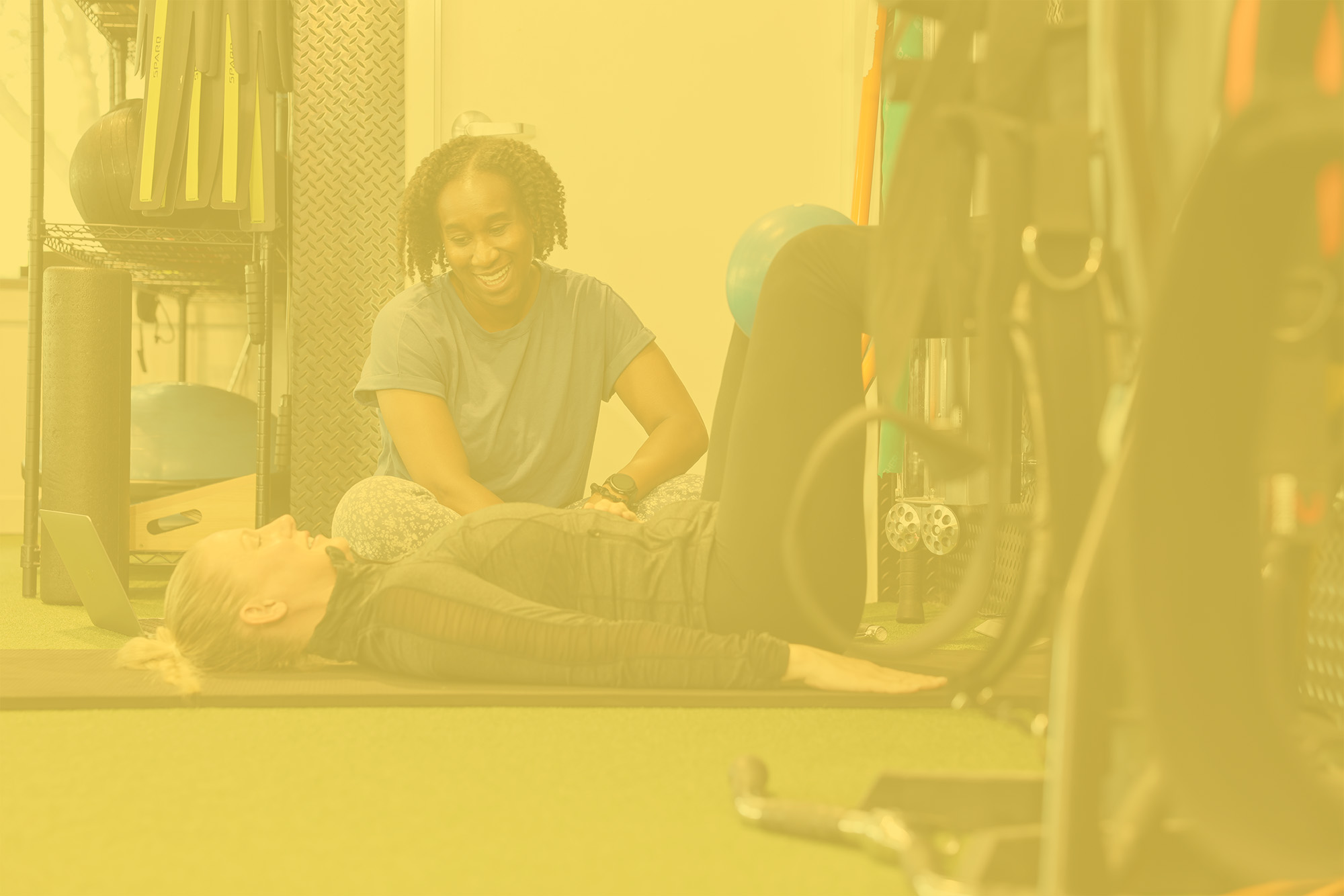 Physical therapist with patient; gold overlay